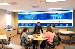 Professor Elena Bray Speth (Biology) talks with students in the Learning Studio.